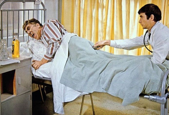 Jim Dale prods the sore bum of Frankie Howerd in Carry on Doctor (1967)